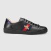 Black leather with red leather detail on the heel of one shoe and blue on the other